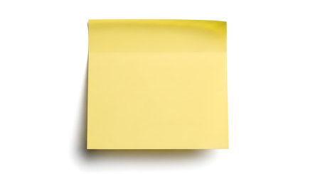 A single, blank yellow sticky note is shown from a top-down perspective against a clean white background, ready for a message.の素材