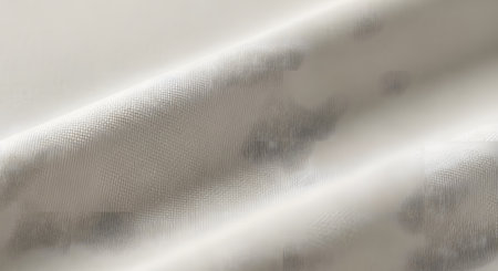A detailed macro shot of a light-colored fabric with a raised, textured pattern and a soft sheen.の素材