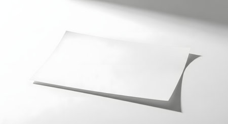 A stark, minimalist composition featuring a sharp geometric shadow cast on a bright white background, creating a sense of depth and form.の素材