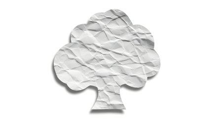 A stylized tree shape cut from crumpled white paper, casting a soft shadow on a plain white surface.の素材