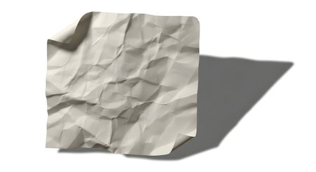 A single sheet of crumpled light-colored paper casts a distinct, elongated shadow on a plain white surface.の素材