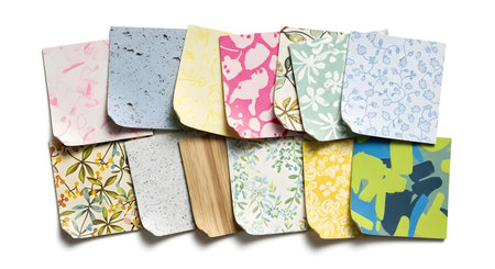 A vibrant assortment of small fabric samples, each showcasing a unique pattern and color palette, neatly arranged together.の素材