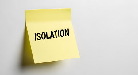 A single yellow sticky note is attached to a white wall. The word 'ISOLATION' is prominently written in black capital letters.の素材