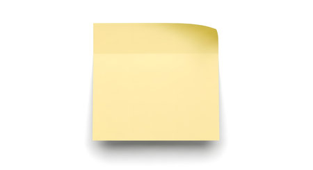 A single, blank yellow sticky note with a slightly curled corner casts a subtle shadow on a clean white surface.の素材