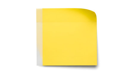 A bright yellow sticky note stands vertically on a white surface. The top right corner is slightly curled upwards, casting a subtle shadow.の素材