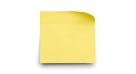 A single, blank yellow sticky note with a gently curled upper right corner is isolated on a clean white surface with a subtle shadow.の素材