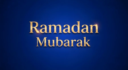 A sophisticated "Ramadan Mubarak" message in shimmering gold text against a deep blue, subtly textured background, perfect for greetings.の素材