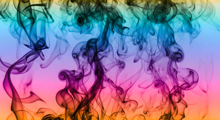 Abstract swirls of colorful smoke in blues, purples, and yellows rise against a soft pink and yellow gradient.の素材