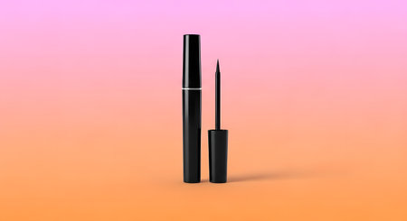 A black eyeliner pen and a fine-tipped liquid eyeliner bottle stand upright against a soft pink and orange gradient.の素材