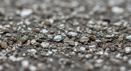 A detailed macro photograph showcases a textured surface composed of small, irregular mineral fragments, many with a metallic sheen.の素材