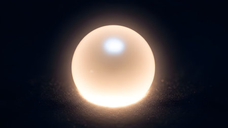 A glowing celestial body is depicted in the image, emitting a bright light against a dark background. The body is spherical in shape and has a radiant glow around it, suggesting it could be a star or a similar celestial entity. The surrounding darkness represents space, emphasizing the body's isolation and luminosity.の素材