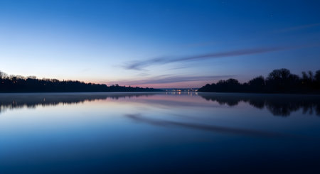 Sunset over the lake with reflection in water. Long exposure.の素材