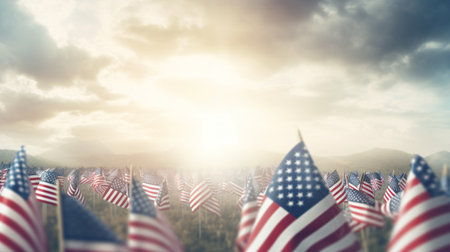 American flags against scenic view of valley under blue sky with white cloudsの素材