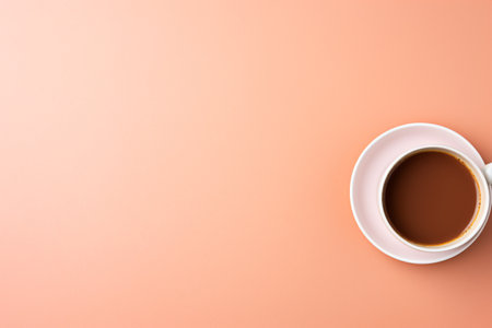 Coffee cup on pink background with copy space, top viewの素材