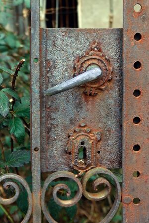 an old rusty metal lock on an abandoned houseの写真素材