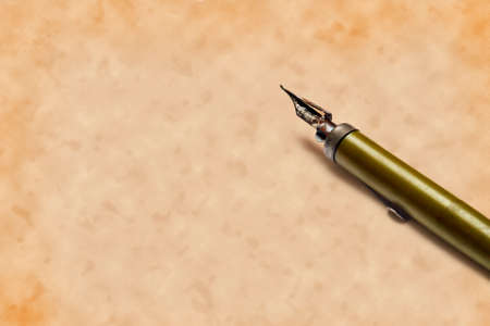 old rusted, neglected nib pen, with remnants of dried ink, on old paper background