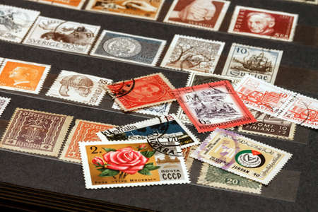 various old postage stamps from various countries in the philatelic albumの素材 [FY310164446307]