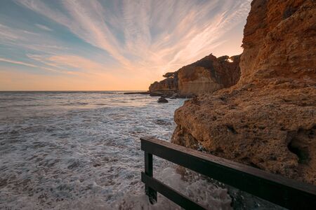 High tide at the beach at Olhos D'Agua in the Algarve on the south coast of Portugal.