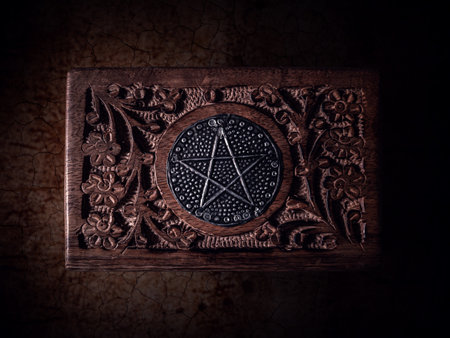Wooden box with pentagram on the lid in close up