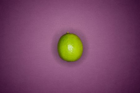 lime on purple backgroundの写真素材