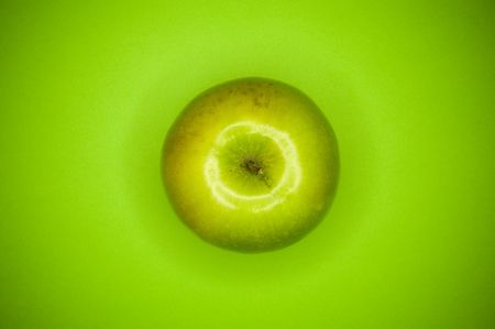 green apple on green backgroundの写真素材