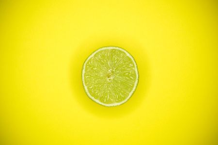 cutted lime on yellow backgroundの写真素材