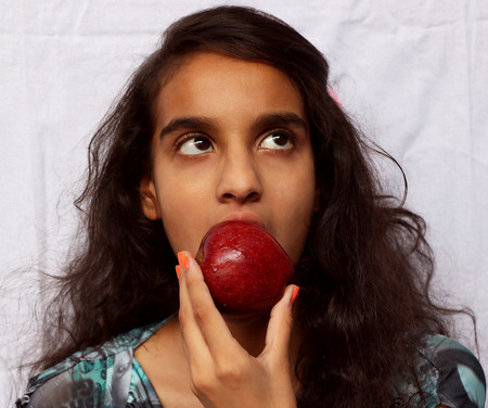 A girl child eating appleの写真素材