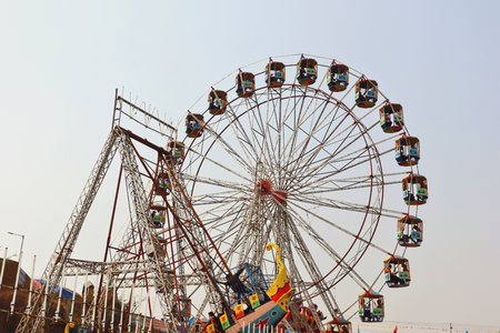 Visitors are enjoying at big swings/giant wheel in Surajkund craft fair.のeditorial素材