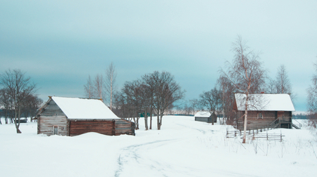 Far lost Karelian village covered deeply with snowの写真素材