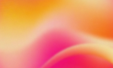 Vibrant orange pink yellow gradient background with grainy texture and soft blendの写真素材