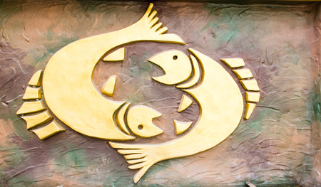 Pisces sign of horoscope on the wallの写真素材