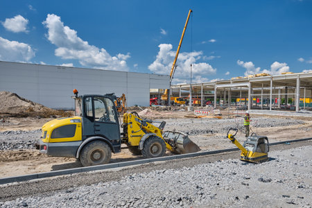 bulldozer and other construction equipment in front of construction site building modern gallery...