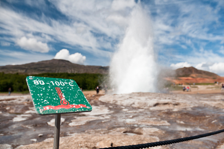 caution hot! erupting Geysir on Icelandの写真素材
