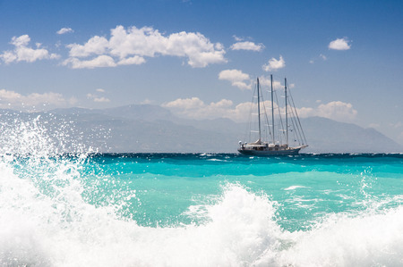 sailship cruising dangerous seas, big wavesの写真素材