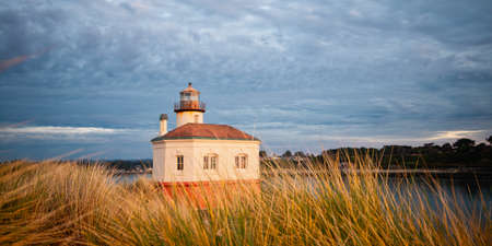 Coquille River Lighthouse in Bandon illuminated by setting sun, Oregonの写真素材