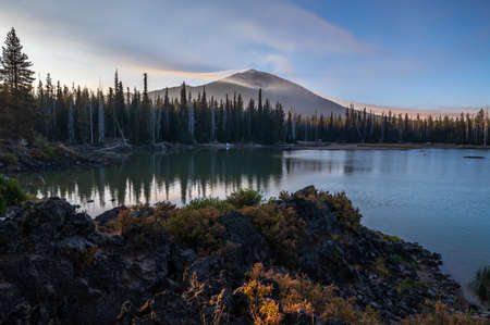 Smoke from distant wildfires 2020 surround Mt. Bachelor in Oregon. Sparks Lake in foreground.の写真素材