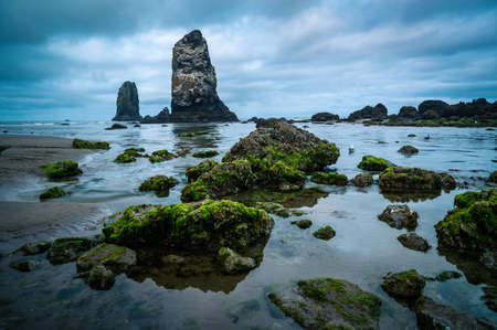 Dramatic blue light over Needles in Cannon Beach, Oregonの写真素材