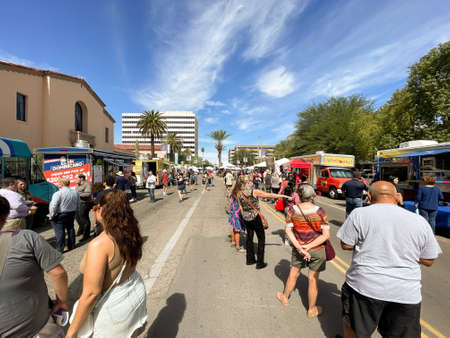 People in line at food trucks at Tucson festival.のeditorial素材