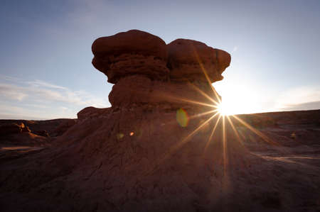 Backlit hoodoos in Goblin Valley State Park in Utah with sunburst
