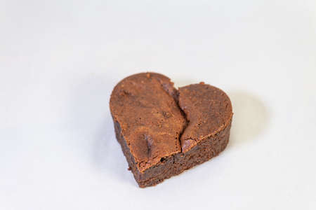 Heart-shaped chocolate brownie on white backgroundの写真素材