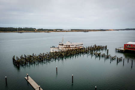 Old ferry boat moored at Empire Dock in Coos Bay, Oregon, aerialの写真素材