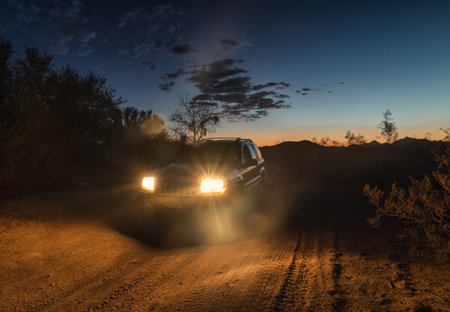 Jeep Grand Cherokee off-roading at night, headlights on.のeditorial素材