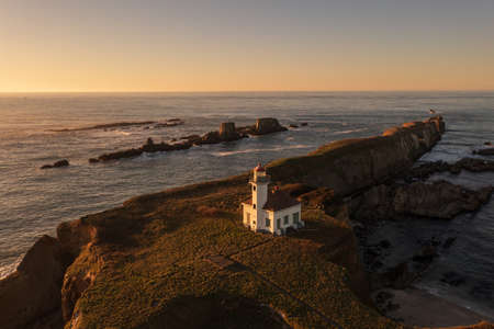 Cape Arago Lighthouse at the Oregon Coast at sunset.の写真素材