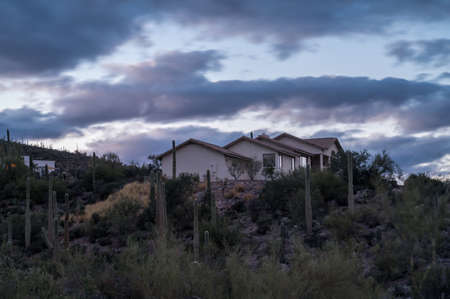 Modern home in Tucson, Arizona, USA with beautiful blue evening sky and landscapingの写真素材