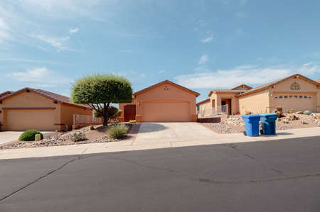 Homes in Green Valley, Arizona with blue trashcans in frontの写真素材