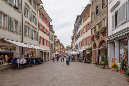 People and tourists walk through the old narrow streets and alleys in Rheinfelden.のeditorial素材