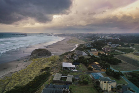 Storm clouds at sunset over homes at the Oregon Coast.の写真素材