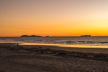 People play at the beach in Southern California. Mexican Coronado Islands in distanceの写真素材