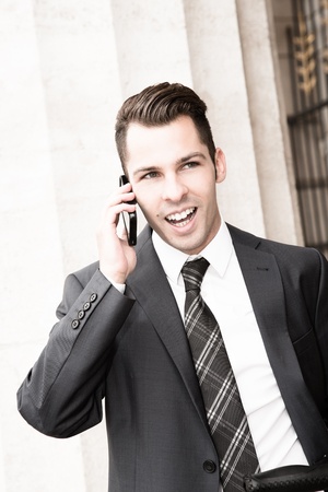 Young businessman using a mobile phoneの写真素材