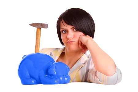 Young woman who thinks about hammering on her piggybankの写真素材